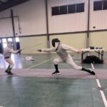 Two people fencing