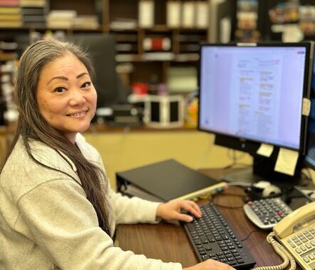 Woman smiling at computer