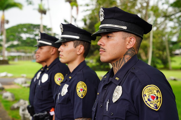 Side profile of three male police recruits