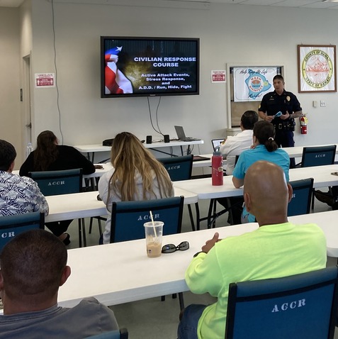 Officer giving a talk at front of classroom